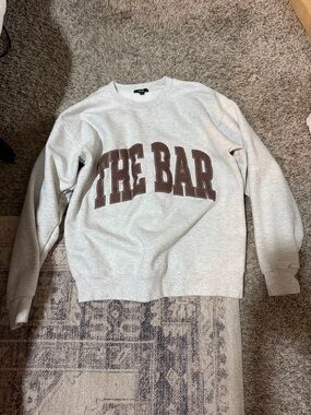 The Bar Crewneck Sweatshirt in Light Gray with Brown Logo